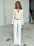 Off white knit cardigan paired with white wide-leg pants