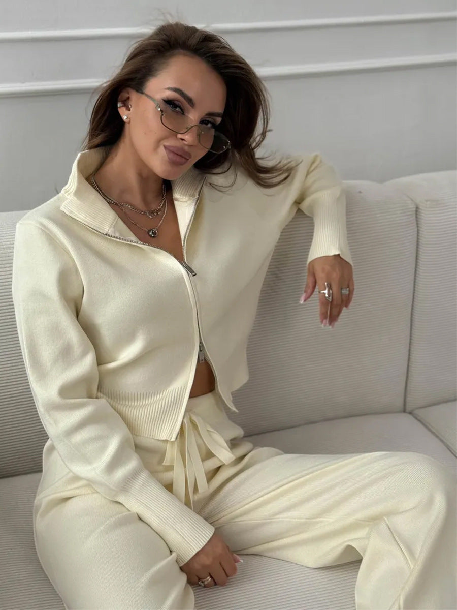 Sitting view of off-white knit 2 piece set with zip jacket and pants