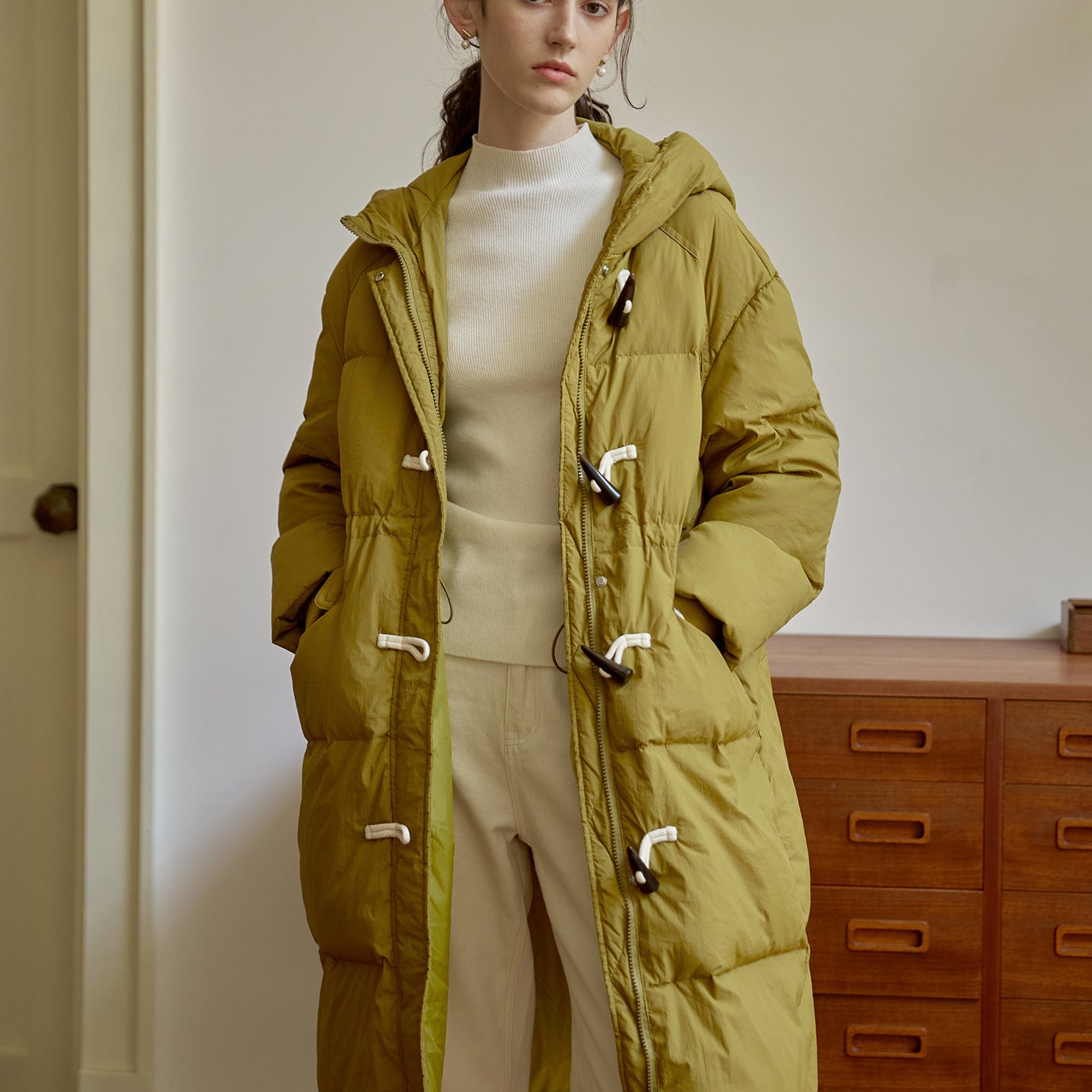 Olive green women’s long puffer coat with hood and zip