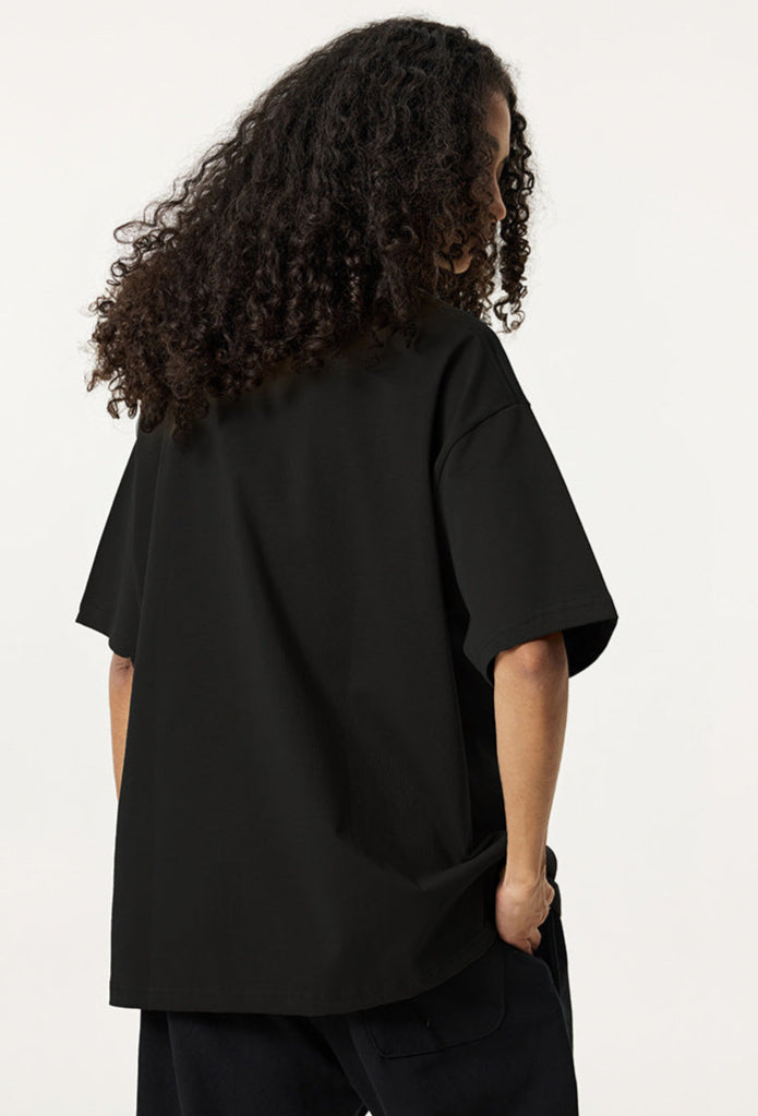 Back view of female model wearing black Ouroboros 8-ball tee