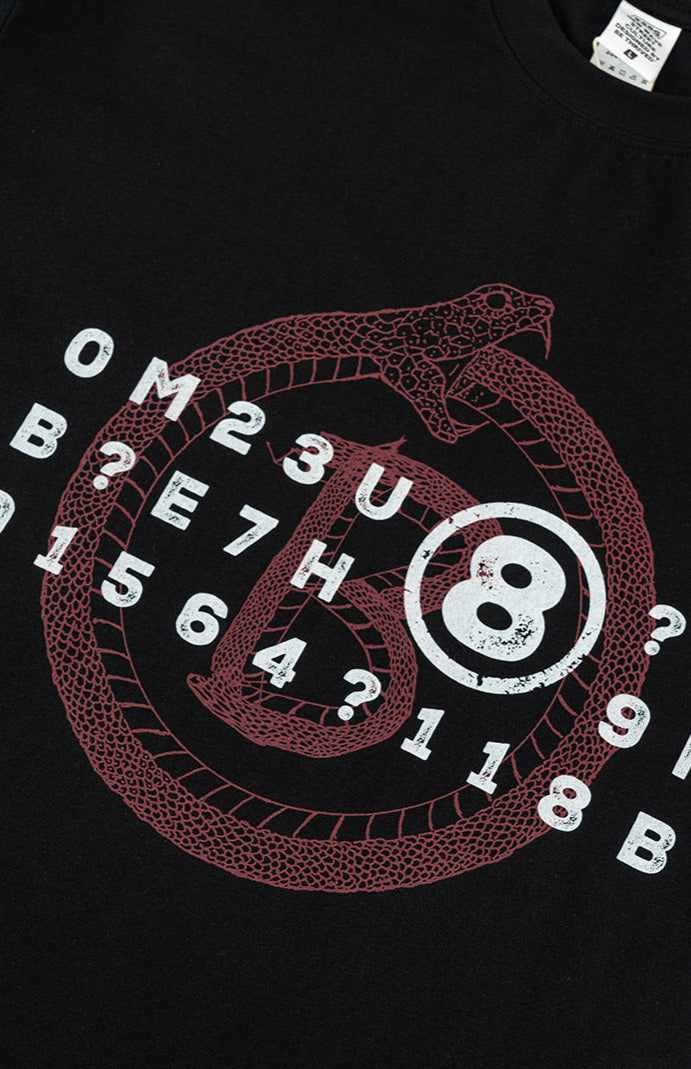 Detailed view of Ouroboros and 8-ball graphic print on black tee