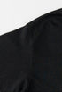 Close-up of shoulder seam on black tee