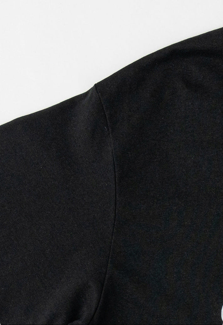 Close-up of shoulder seam on black tee