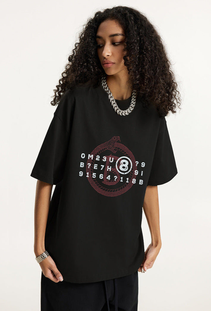 Woman wearing black graphic t-shirt turned slightly to the side.