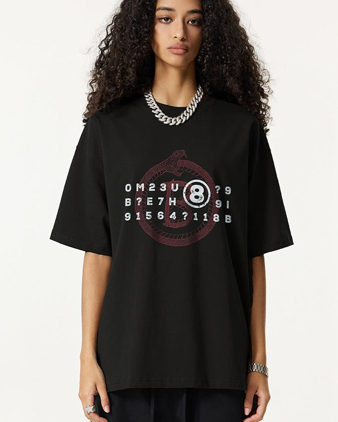 Closeup of woman in black graphic tee with Ouroboros and 8-ball design.