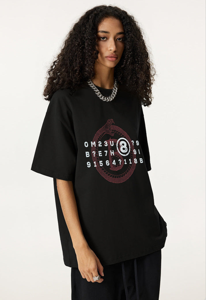 Side view of woman in black oversized t-shirt with cryptic snake and 8-ball graphic.