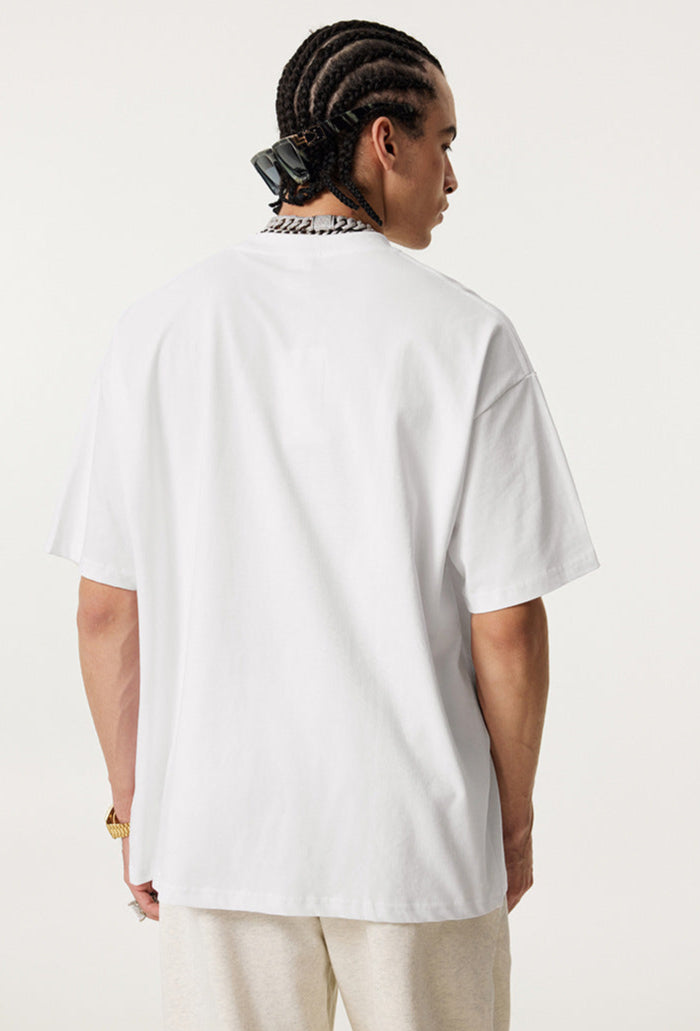 Back view of plain white oversized ouroboros 8ball t-shirt worn by man with braided hair.