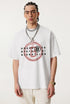 Closeup of man wearing white Ouroboros 8-ball graphic t-shirt with chain necklace.
