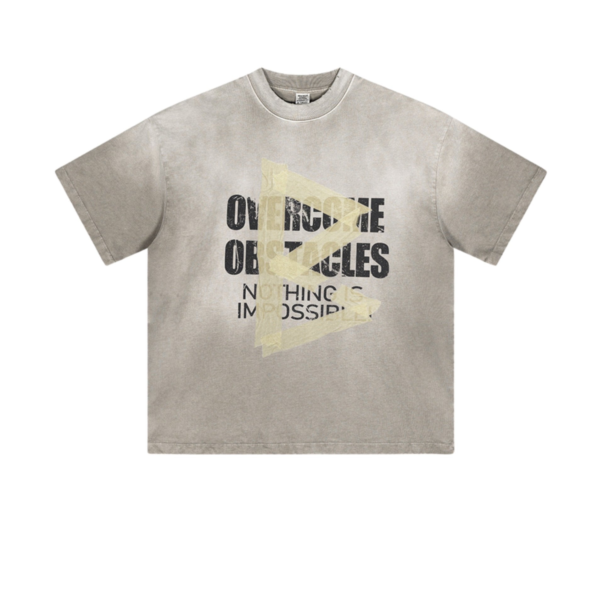 Flat lay of light gray oversized T-shirt with distressed “Overcome Obstacles” and “Nothing is Impossible” text.