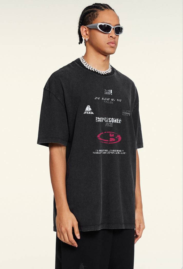 Angled pose of model in black oversized tee with white and red print