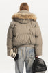 Back view of model wearing a short khaki quilted puffer coat featuring a wide faux fur lined hood.