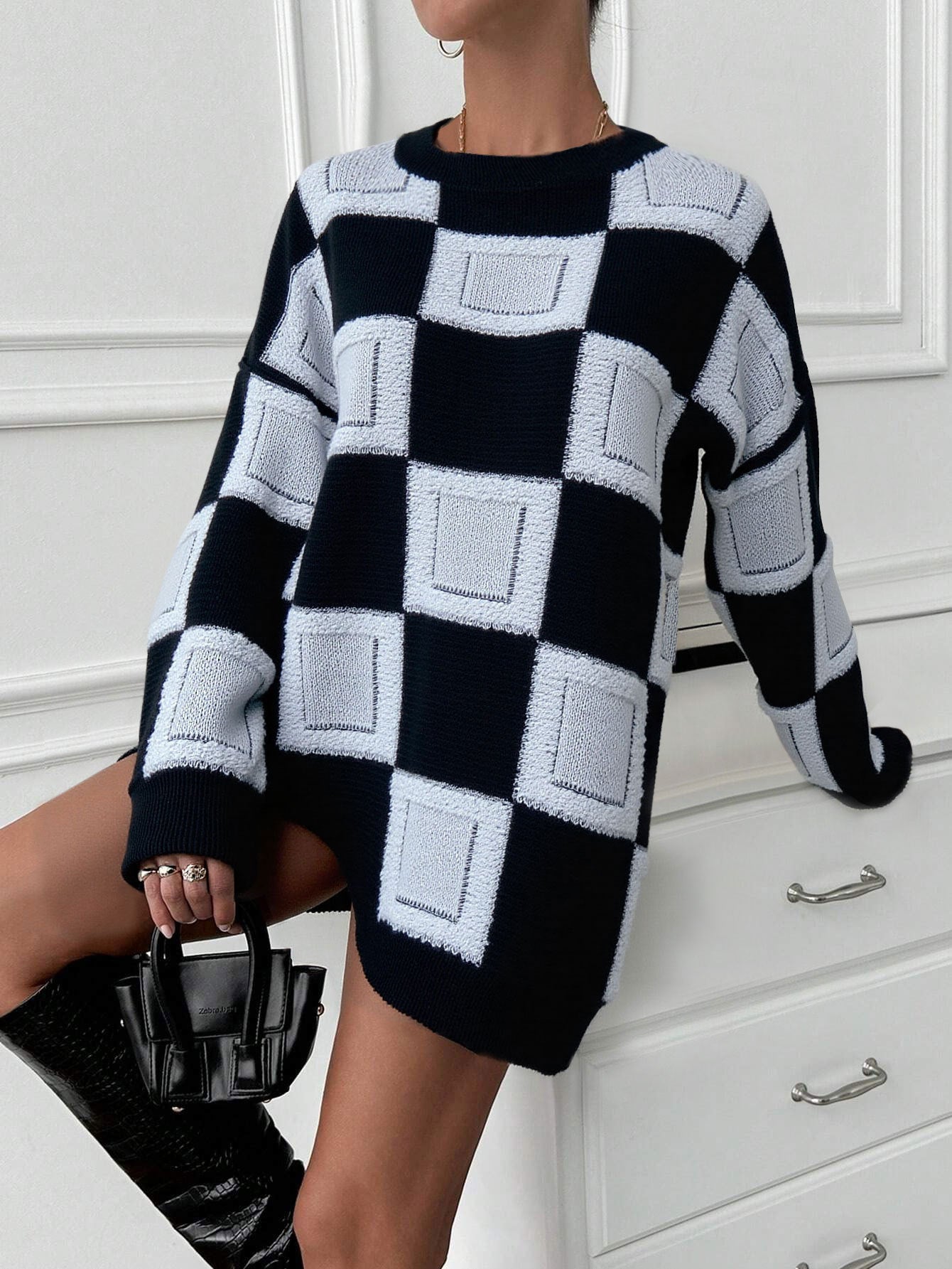 oversized black mock neck sweater with white geometric squares