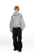 Male model styled in heather gray high neck oversized zip hoodie paired with black cargo trousers.