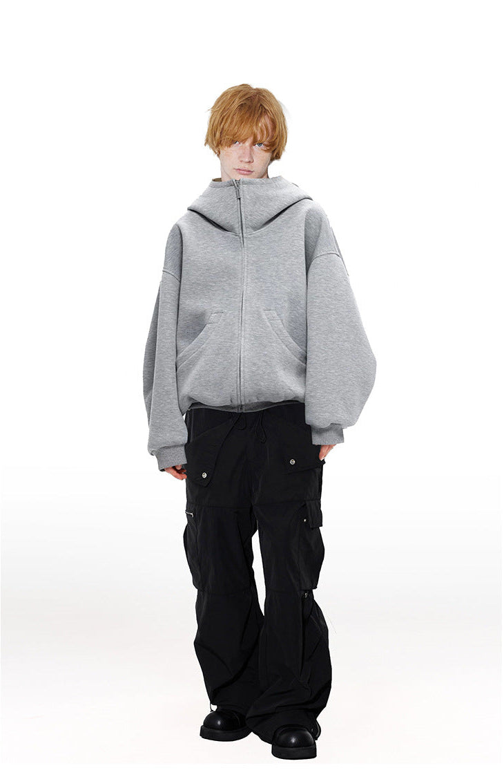 Male model styled in heather gray high neck oversized zip hoodie paired with black cargo trousers.