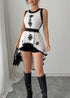 Close-up of black contrast floral details on white sleeveless peplum blouse