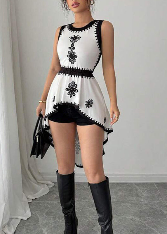 Close-up of black contrast floral details on white sleeveless peplum blouse