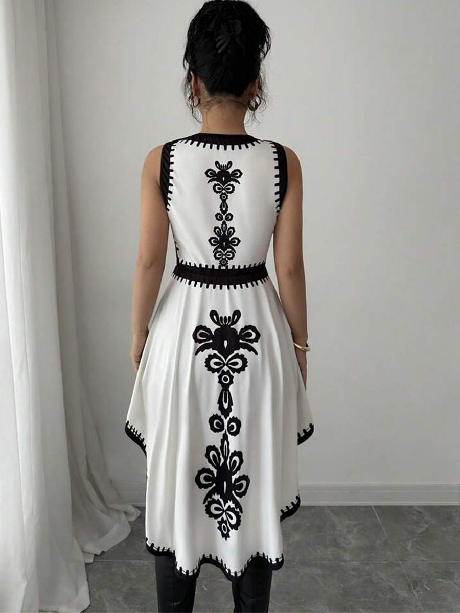 Back view of asymmetrical peplum top with black and white floral embroidery