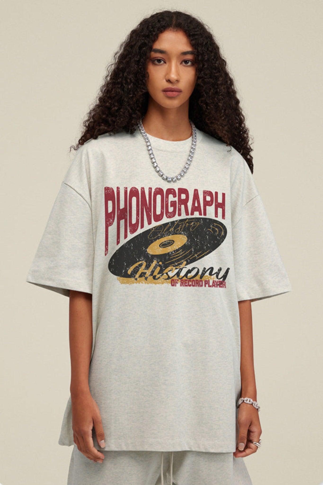 Woman centered in oat grey phonograph graphic tee.