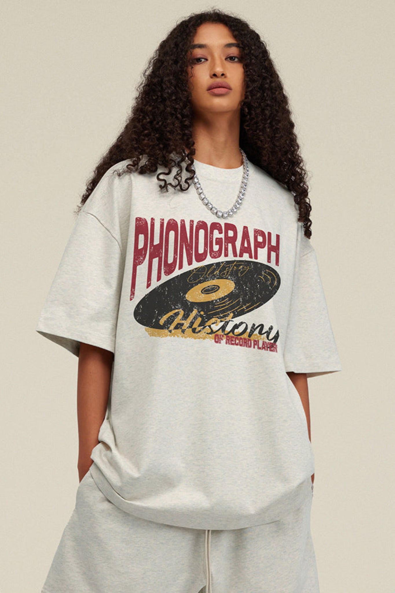 Close-up of phonograph graphic on oat grey tee.