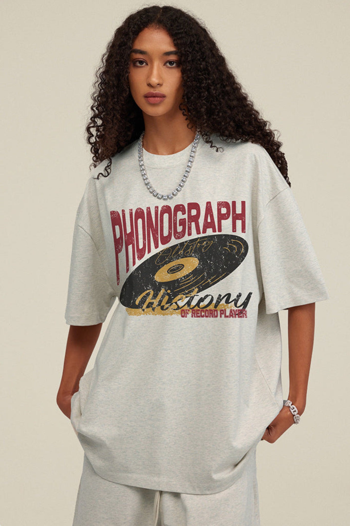 Zoomed detail of light grey tee with phonograph design