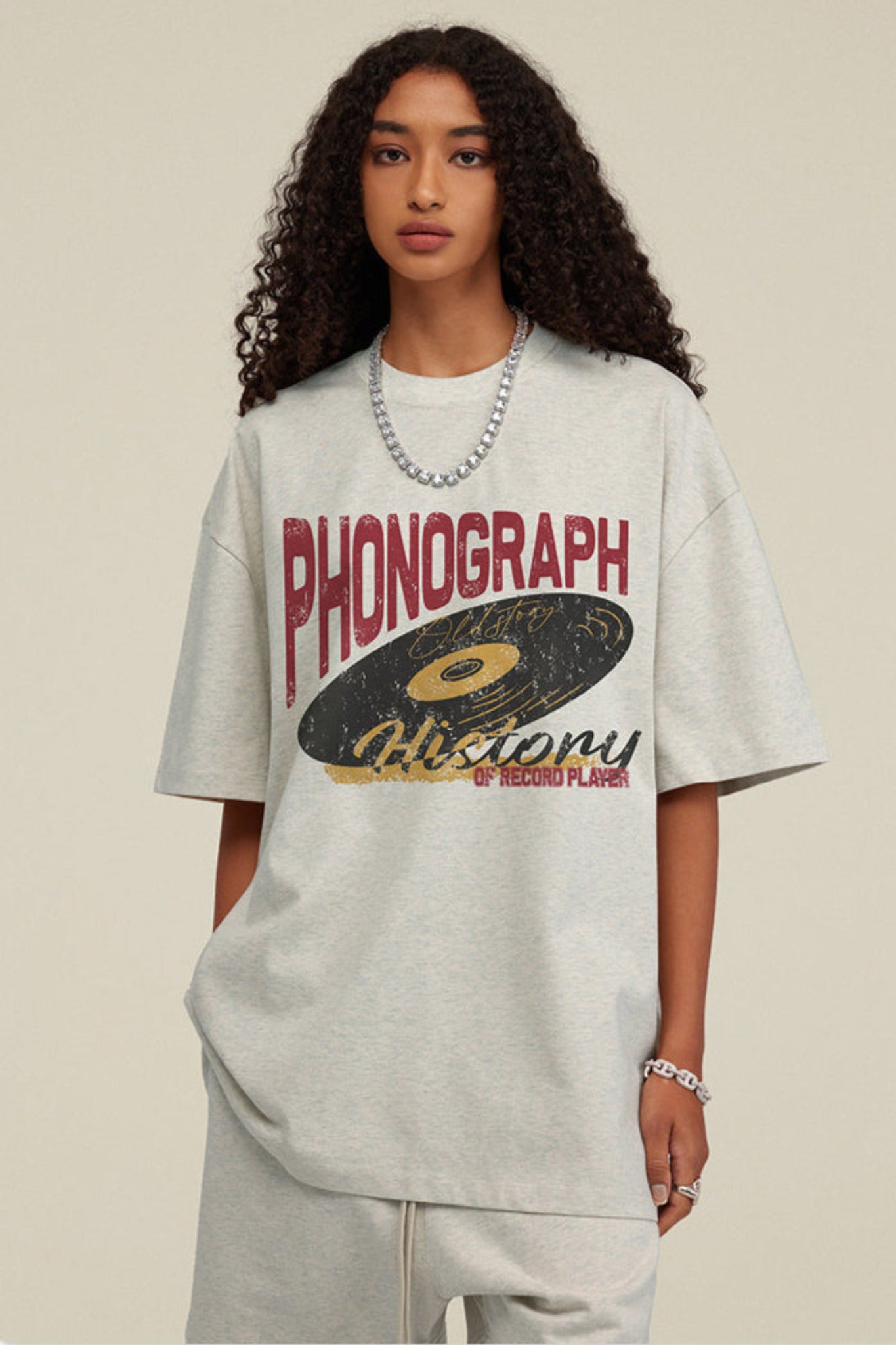 Zoomed detail of oat grey tee with phonograph design.