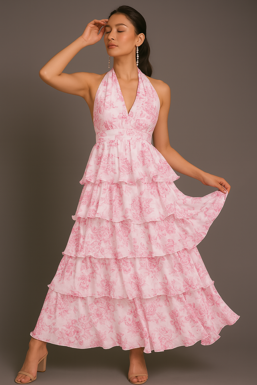Woman wearing a pink tiered dress against a gray background