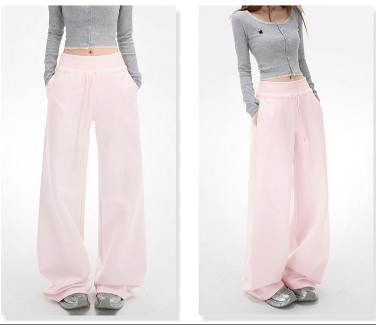 Fleece-lined pink drawstring pants for women, styled for casual comfort, focused view.
