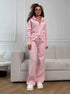 Woman wearing pink knit 2 piece set with zip jacket and wide leg pants