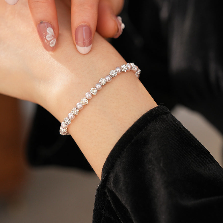 pink pearl beaded bracelet worn on wrist with hand turned inward