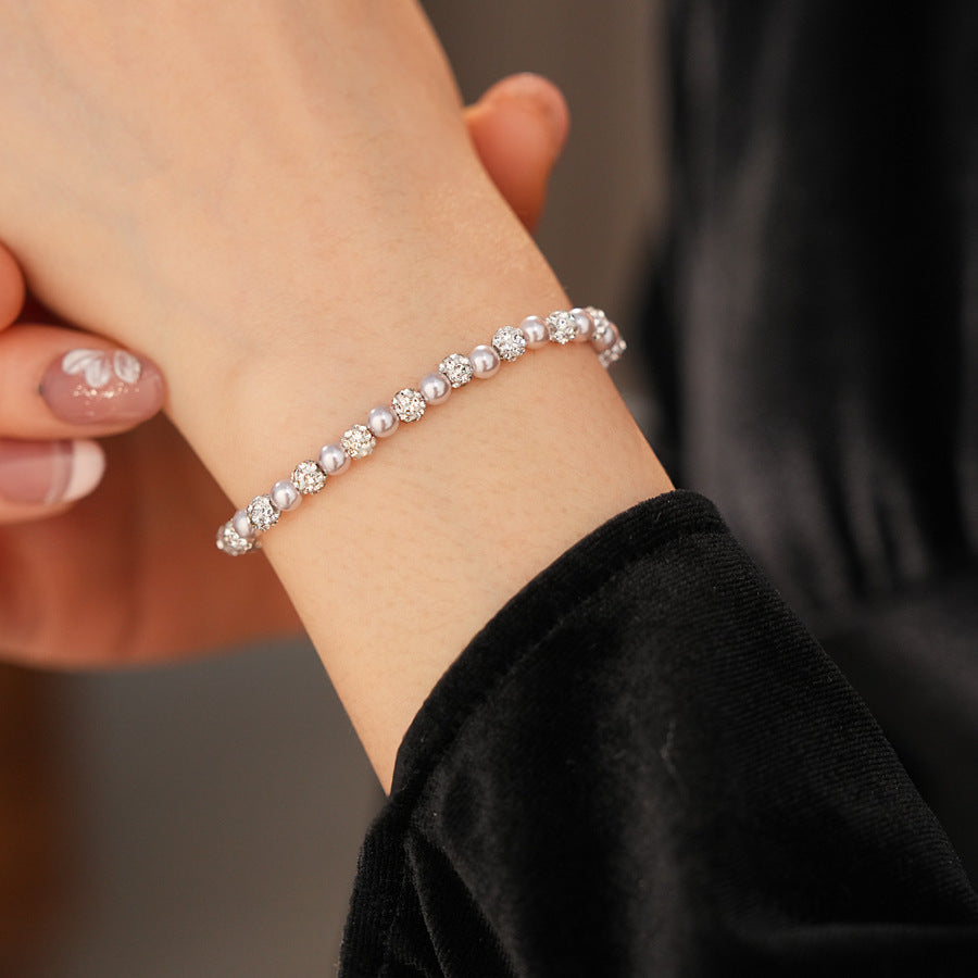 pink pearl rhinestone beaded bracelet worn on the wrist with hand slightly lifted