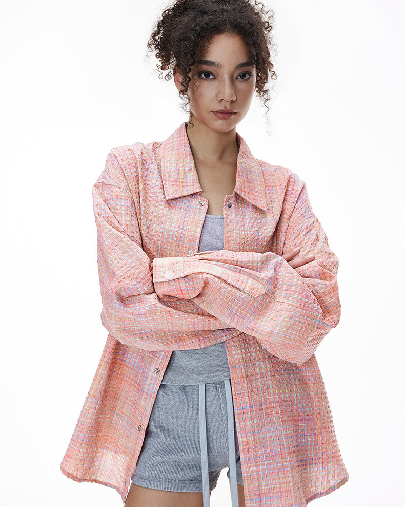 Pink plaid shirt open over mini dress, casual layer