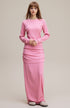 Model wearing pink women’s long sleeve tee with matching skirt full body view