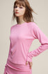 Side view of pink women’s long sleeve tee showing soft cotton texture
