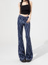 Woman posing in blue plaid bell-bottom pants styled with black top and platform shoes.