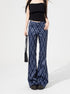 Woman wearing blue plaid high-waist flared pants with front pockets and black tube top.