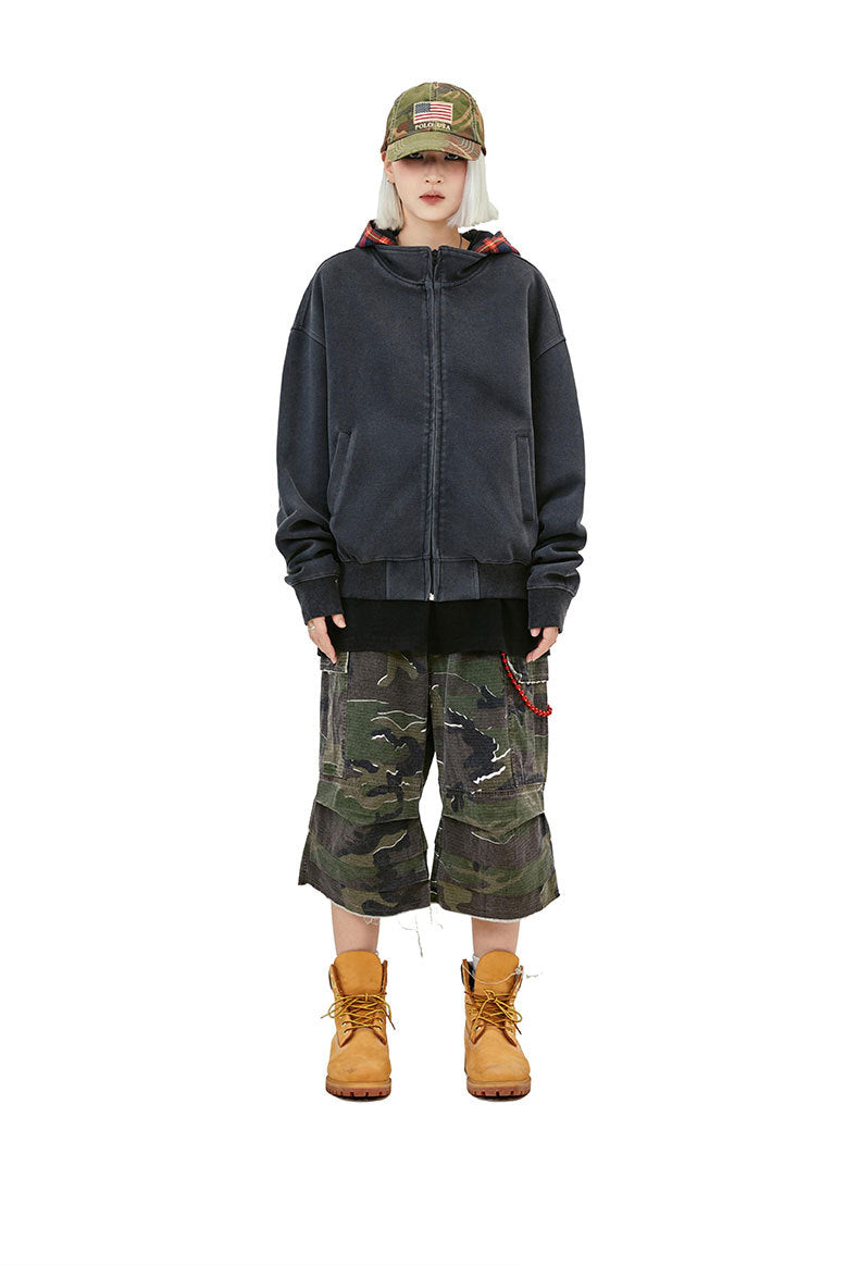 Washed black plaid hood zip-up hoodie styled with camo shorts and work boots