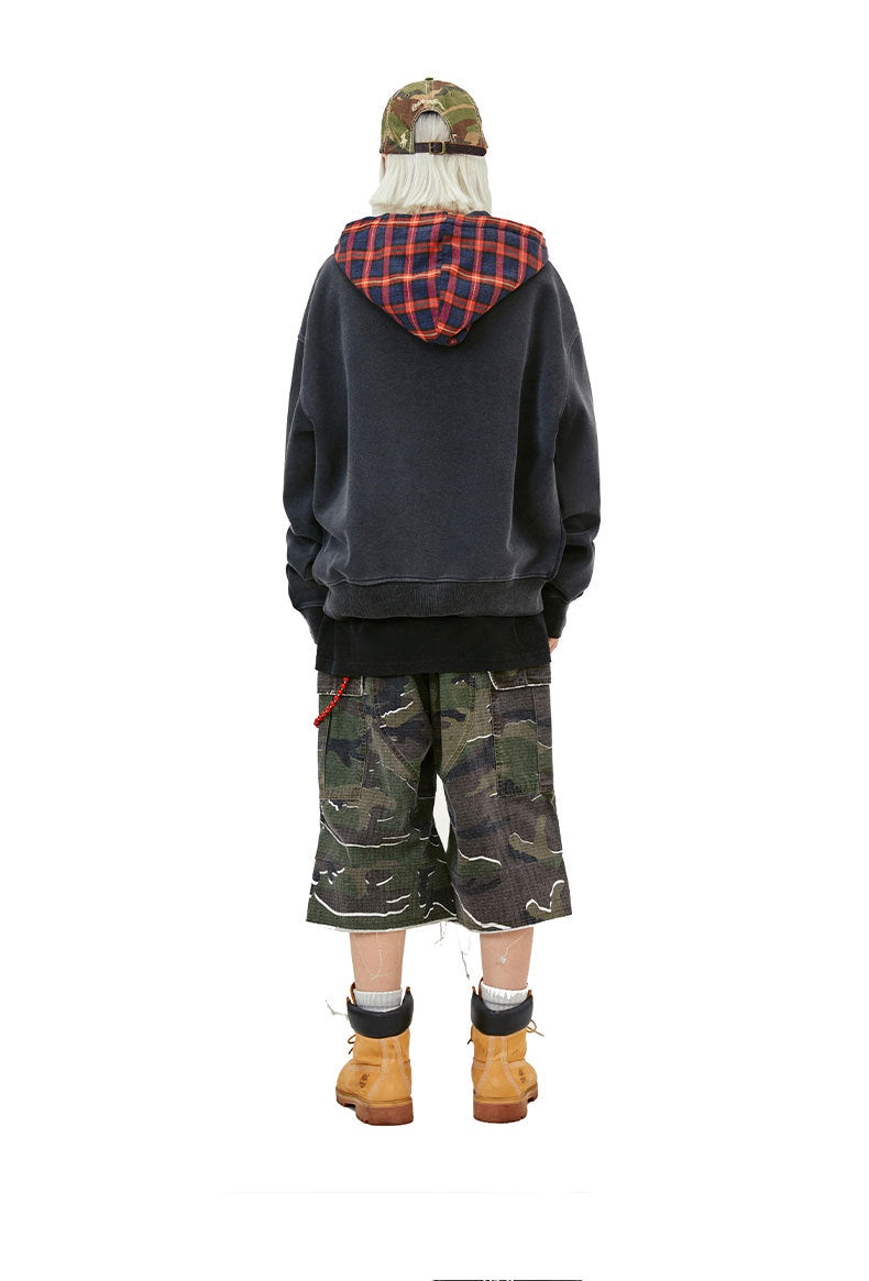 Back view of the washed black hoodie showing the red plaid contrast hood