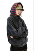 Three-quarter view of the black oversized hoodie showing dropped shoulders and welt pocket