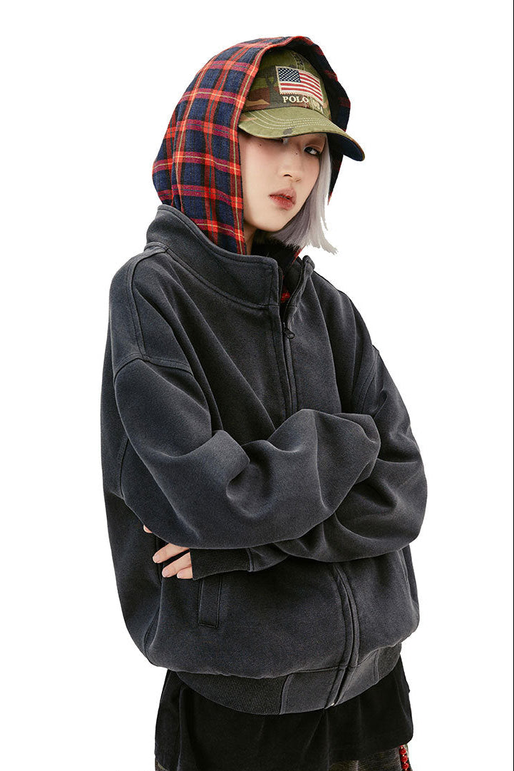 Three-quarter view of the black oversized hoodie showing dropped shoulders and welt pocket