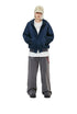 Washed navy zip-up hoodie worn open over a white graphic T-shirt