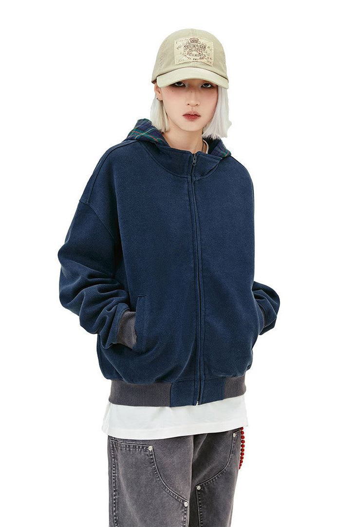 Front close view of the navy oversized hoodie with full zipper and welt pockets