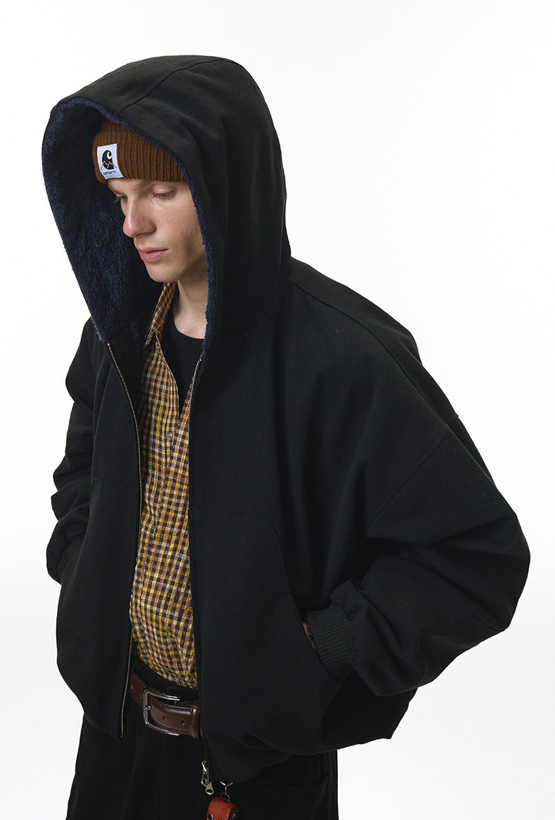 Model wearing black plush zip jacket, side view