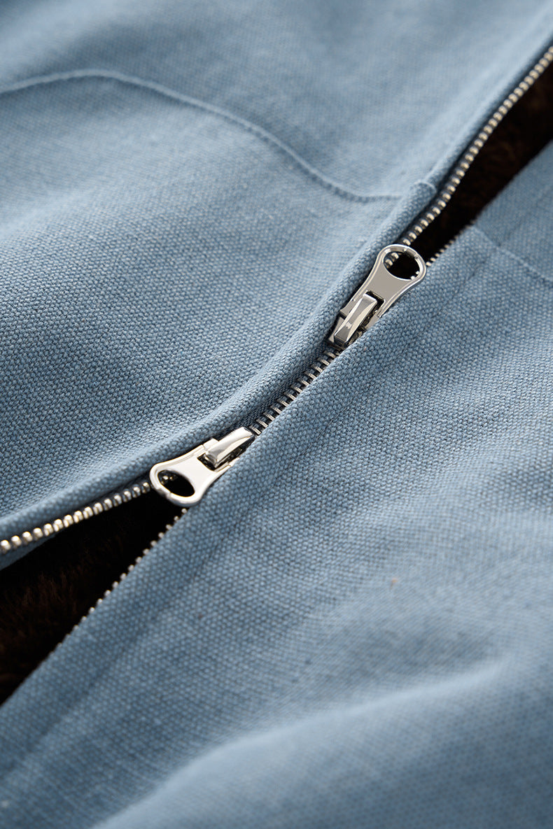 Blue plush zip jacket, double-zipper close-up.