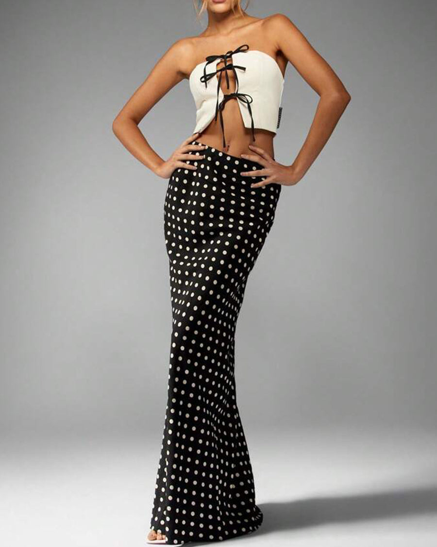 polka dot high-waist maxi skirt, black with cream dots, column silhouette, full front view on model