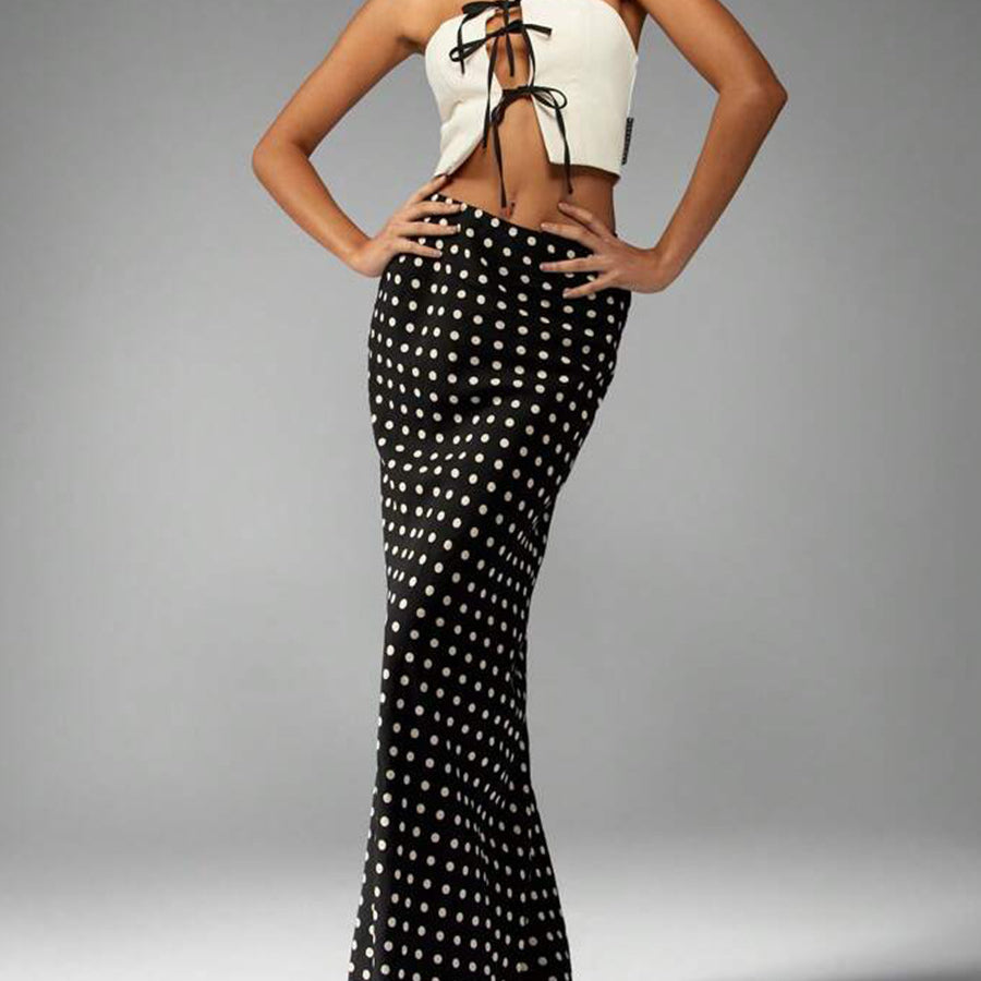 polka dot high-waist maxi skirt, black with cream dots, column silhouette, full front view on model
