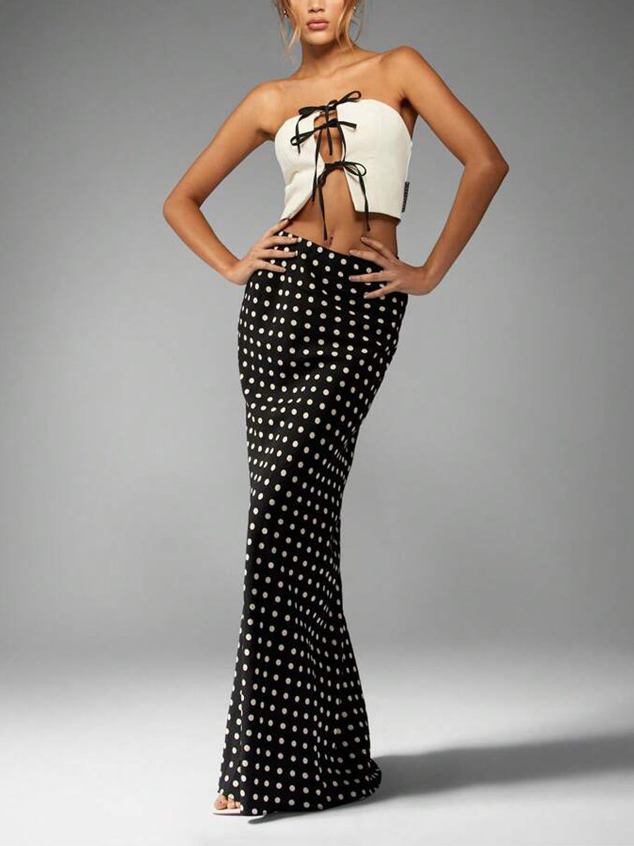 polka dot high-waist maxi skirt, black with cream dots, column silhouette, full front view on model