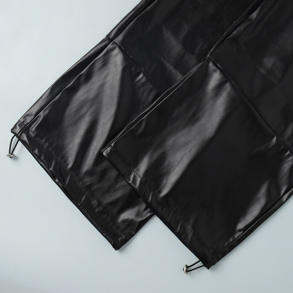PU leather pants folded view black glossy finish