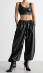 PU leather women’s pants styled with crop top and heels