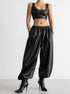 PU leather women’s pants styled with crop top and heels