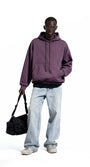Purple oversized hoodie front view on model, roomy street fit